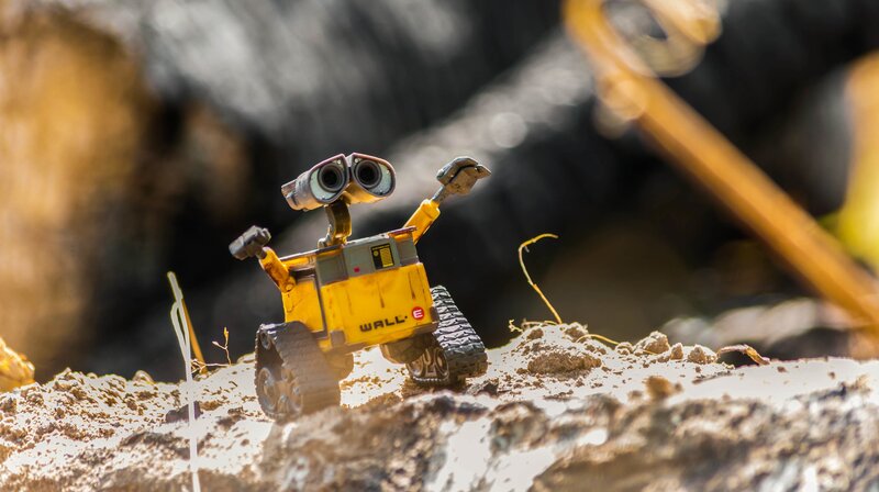 Yellow Robot on Rocky Ground