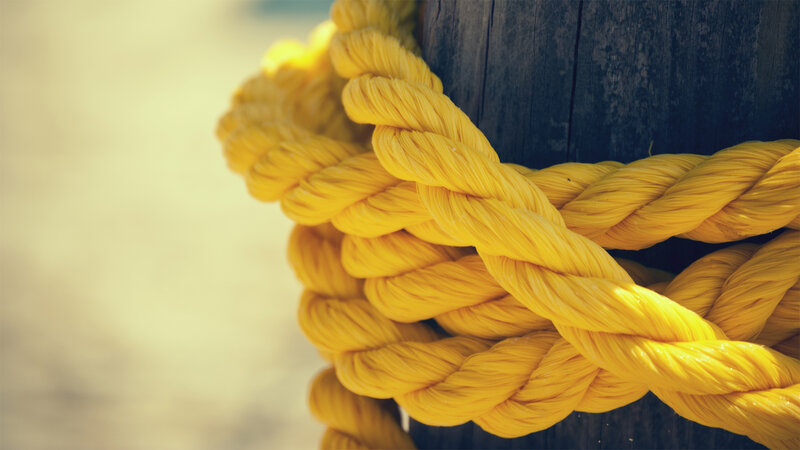 yellow rope on wooden post