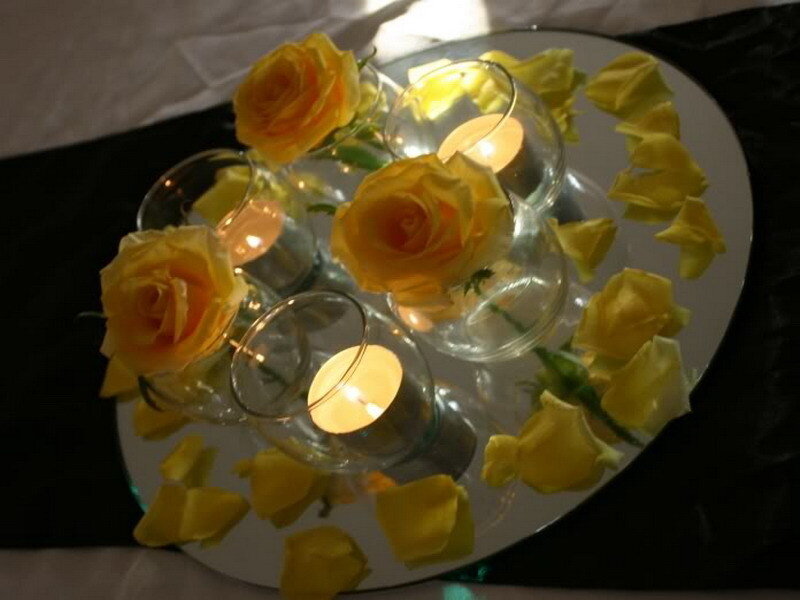 yellow roses and candles centerpiece