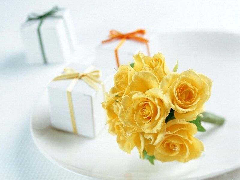 Yellow roses and gift boxes