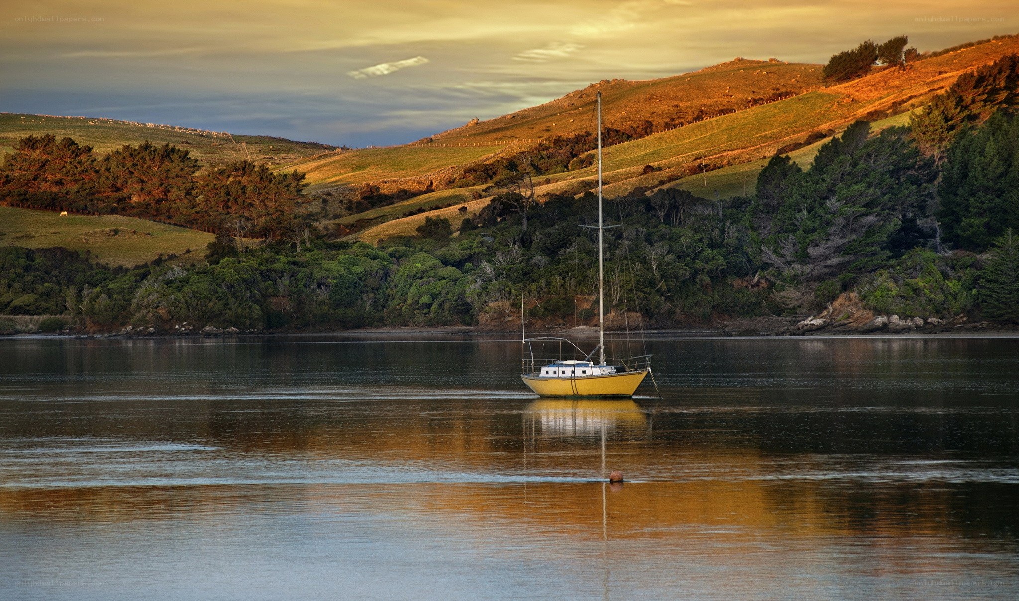 Yellow sailboat at sunset
