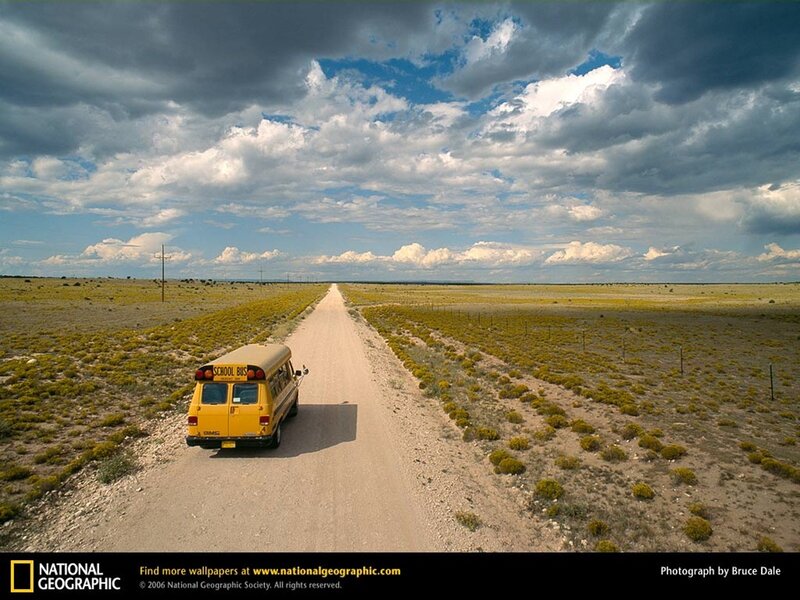 Yellow school bus on a desert road
