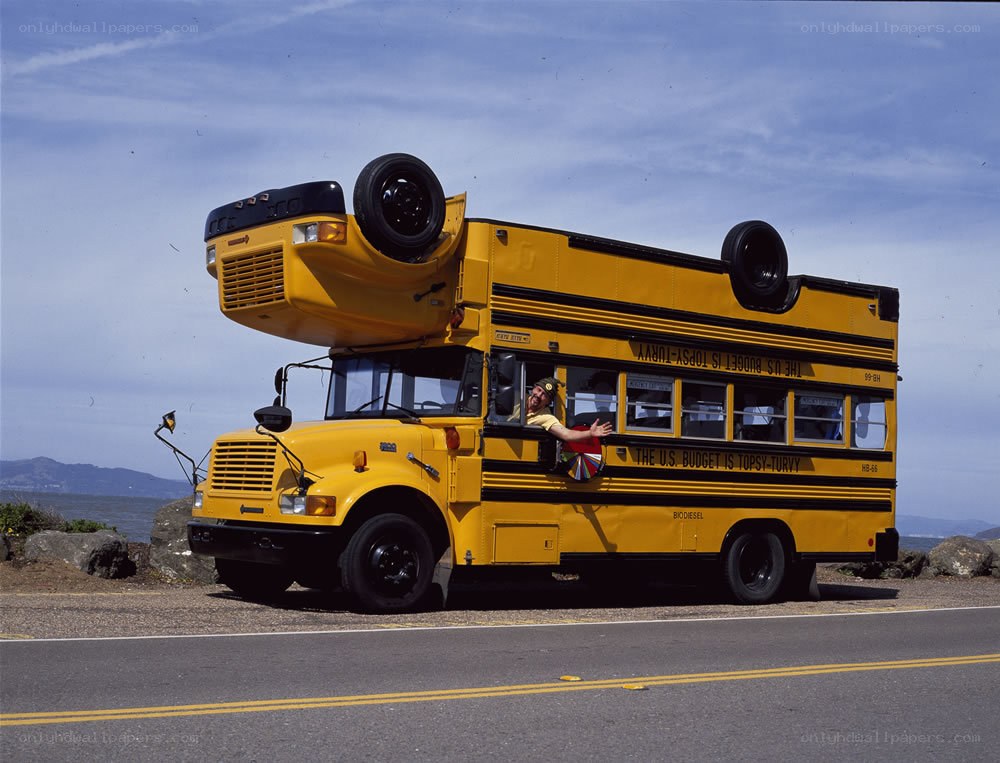 Yellow school bus on its roof