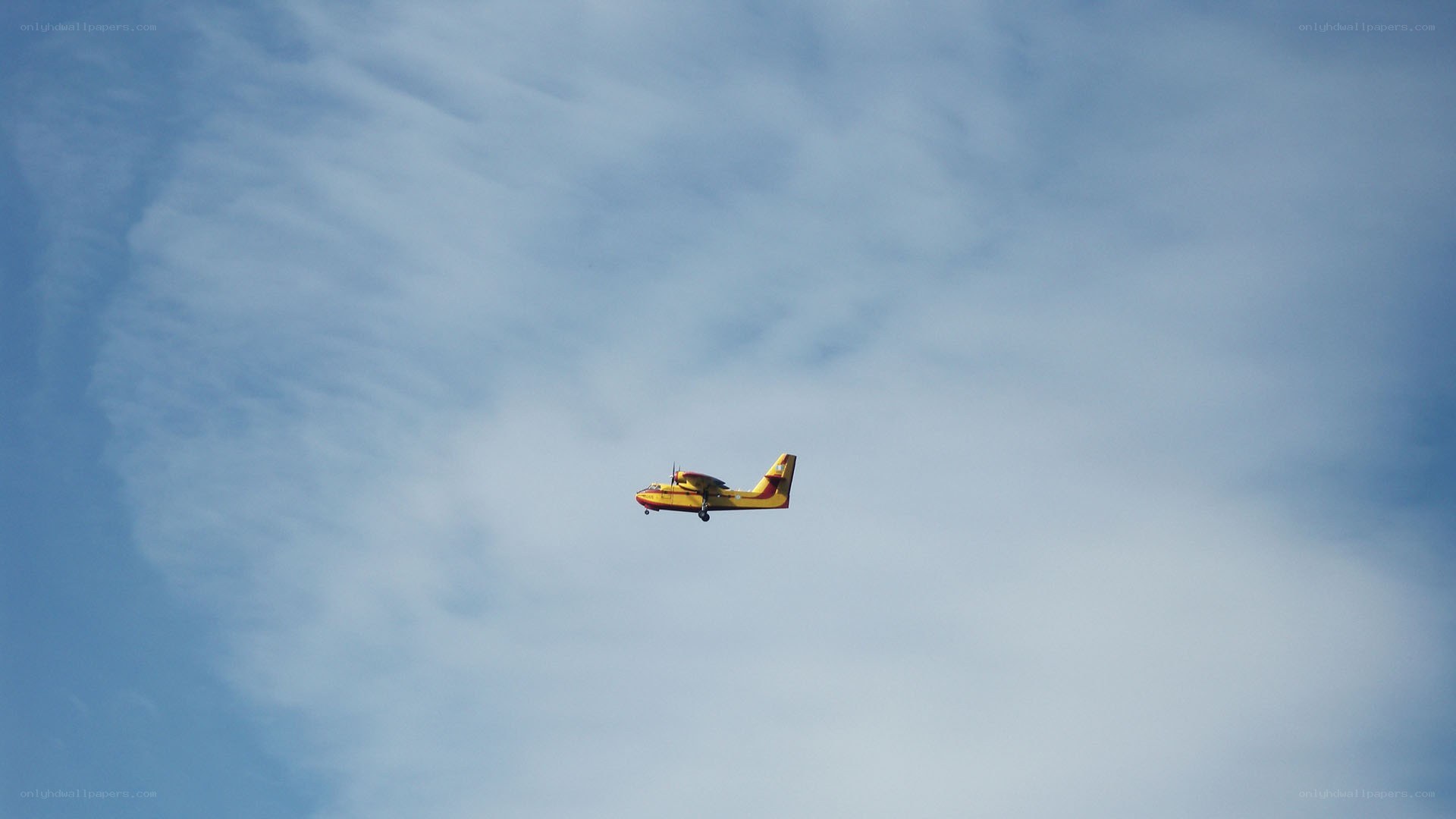 yellow seaplane in blue sky