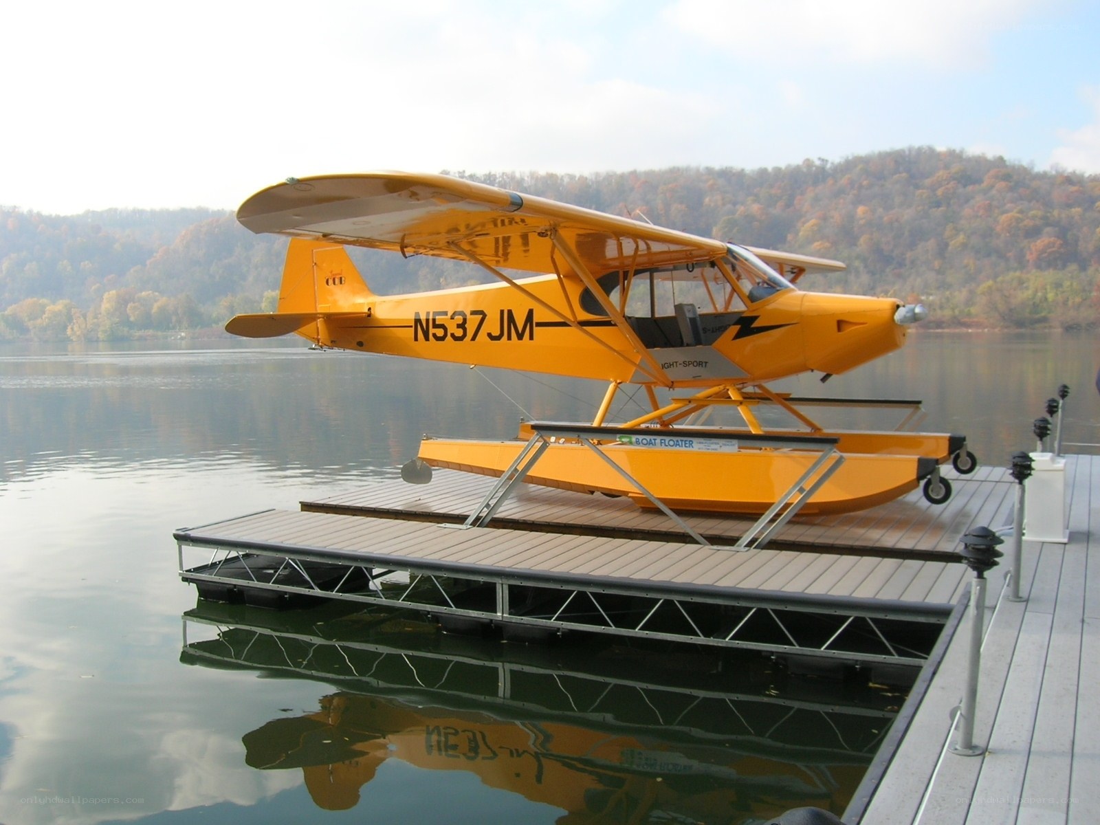 Yellow seaplane on a dock