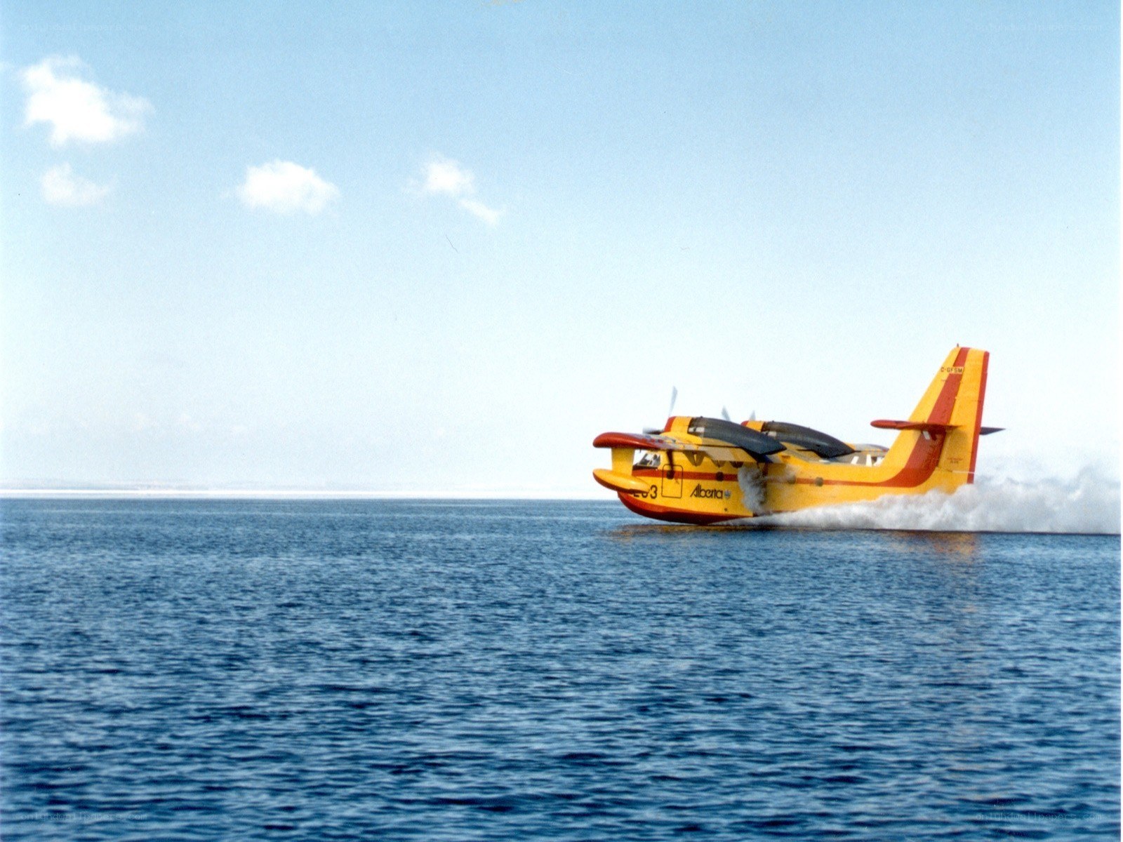Yellow seaplane on water