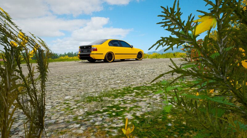 Yellow Sedan on Gravel
