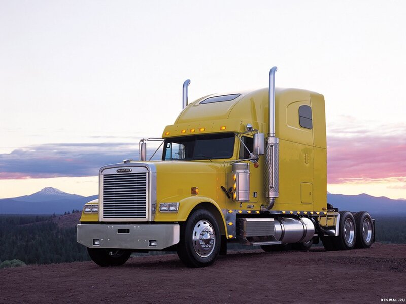 Yellow semi-truck at sunset