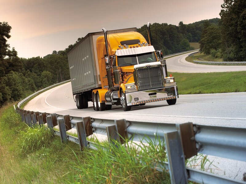 Yellow semi-truck on winding road