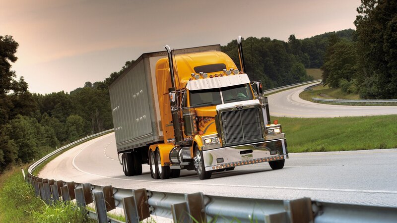 Yellow semi-truck on winding road