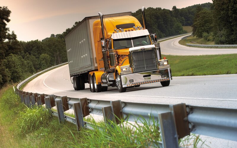 Yellow semi-truck on winding road