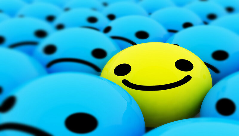 yellow smiley among blue frowns
