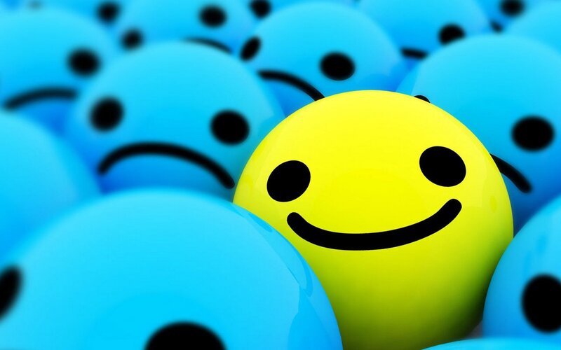 yellow smiley among blue frowns