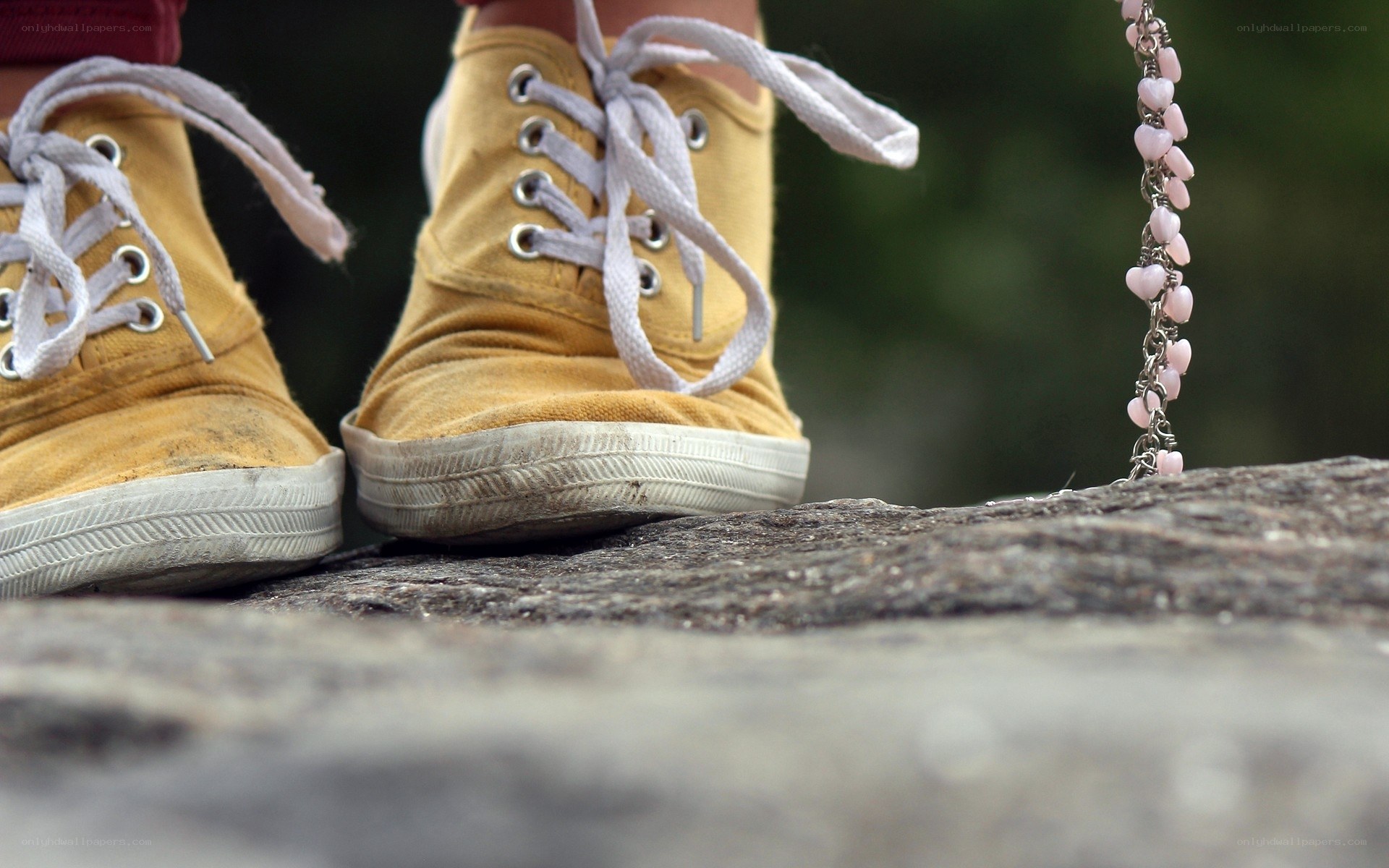 yellow sneakers on a rock