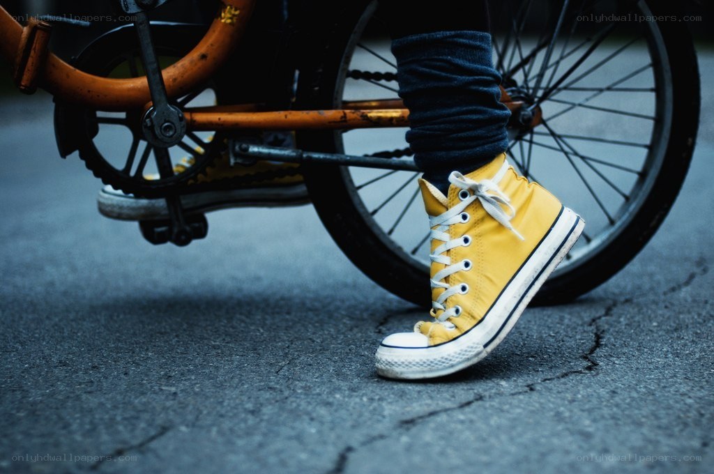 yellow sneakers on pavement