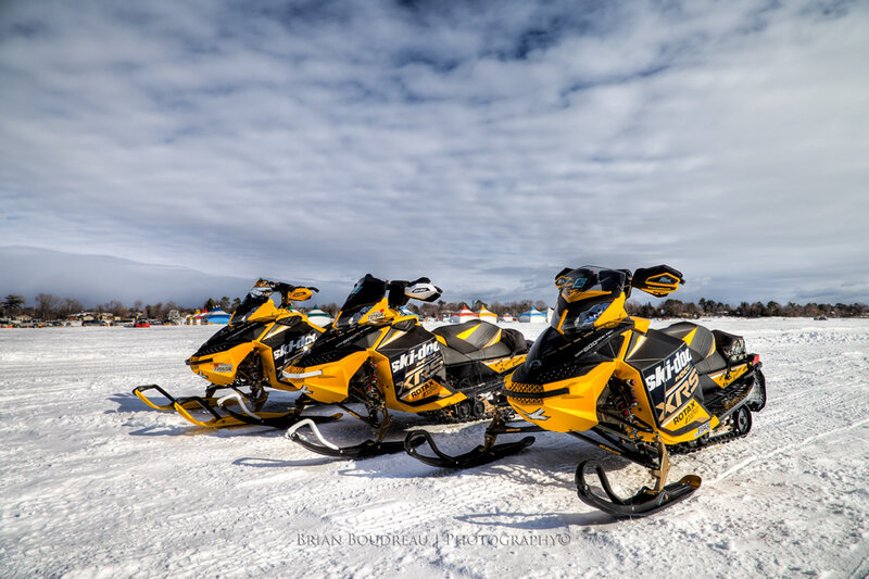 Yellow Snowmobiles on Ice