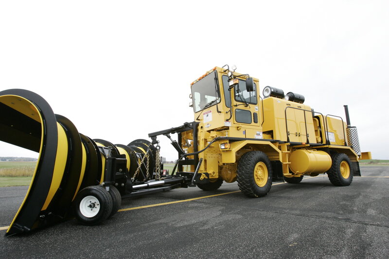 Yellow snowplow truck on pavement