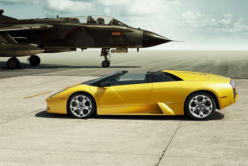 Yellow sports car and fighter jet