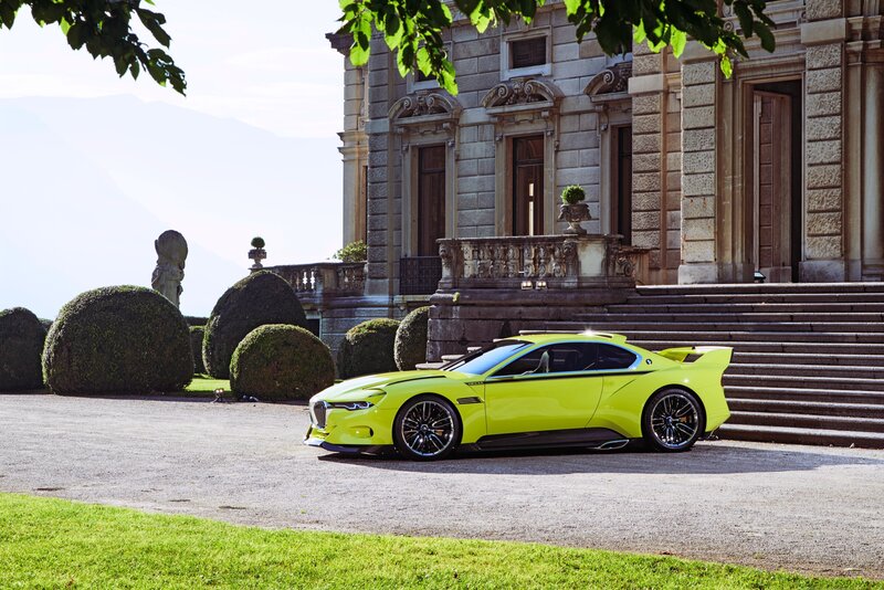 Yellow sports car at a mansion
