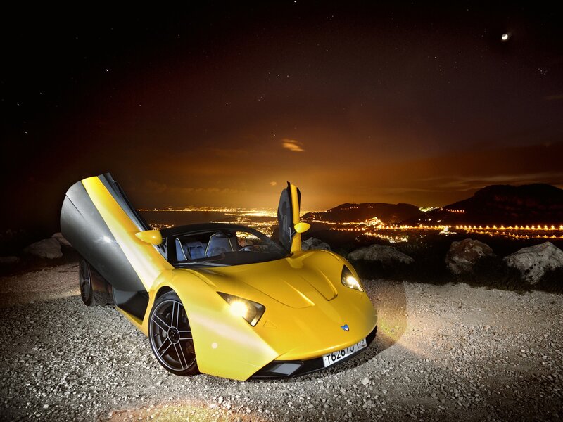 Yellow sports car at night