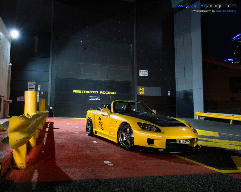 Yellow sports car at night