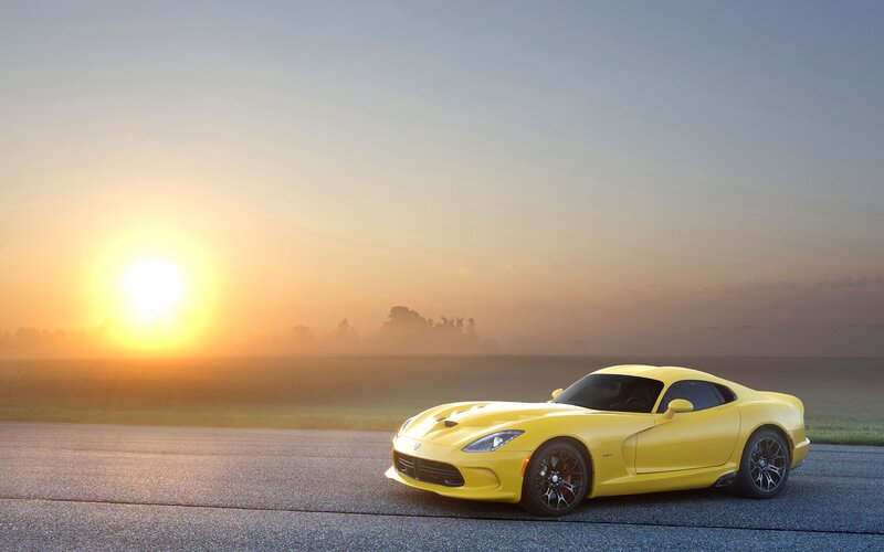 Yellow sports car at sunrise