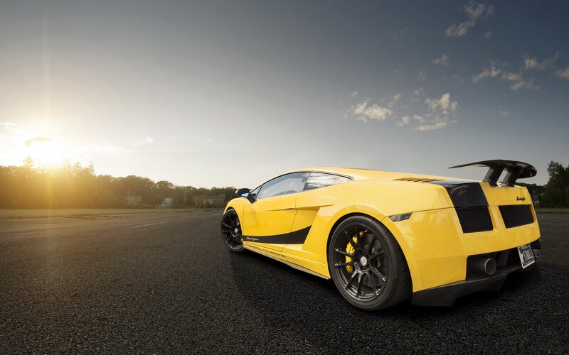 yellow sports car at sunset