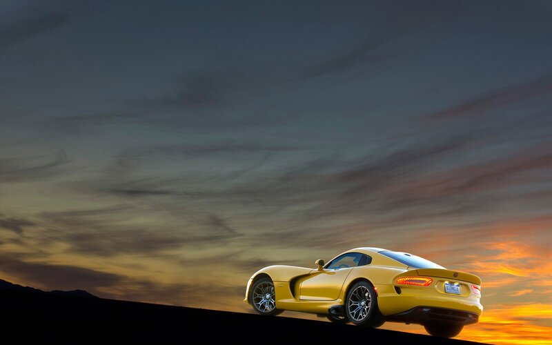 Yellow sports car at sunset