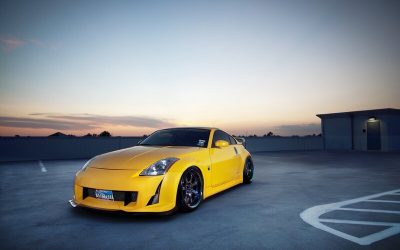 yellow sports car at sunset