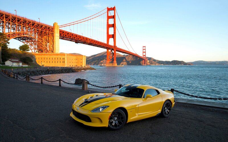 Yellow sports car by Golden Gate Bridge