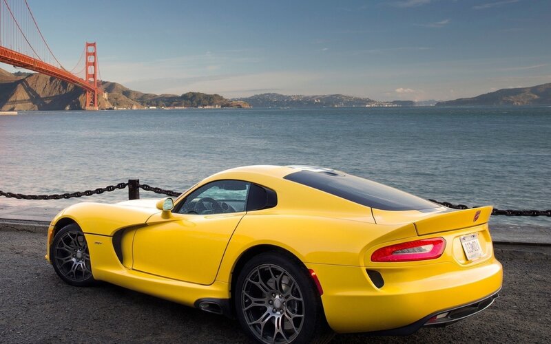 Yellow sports car by Golden Gate Bridge