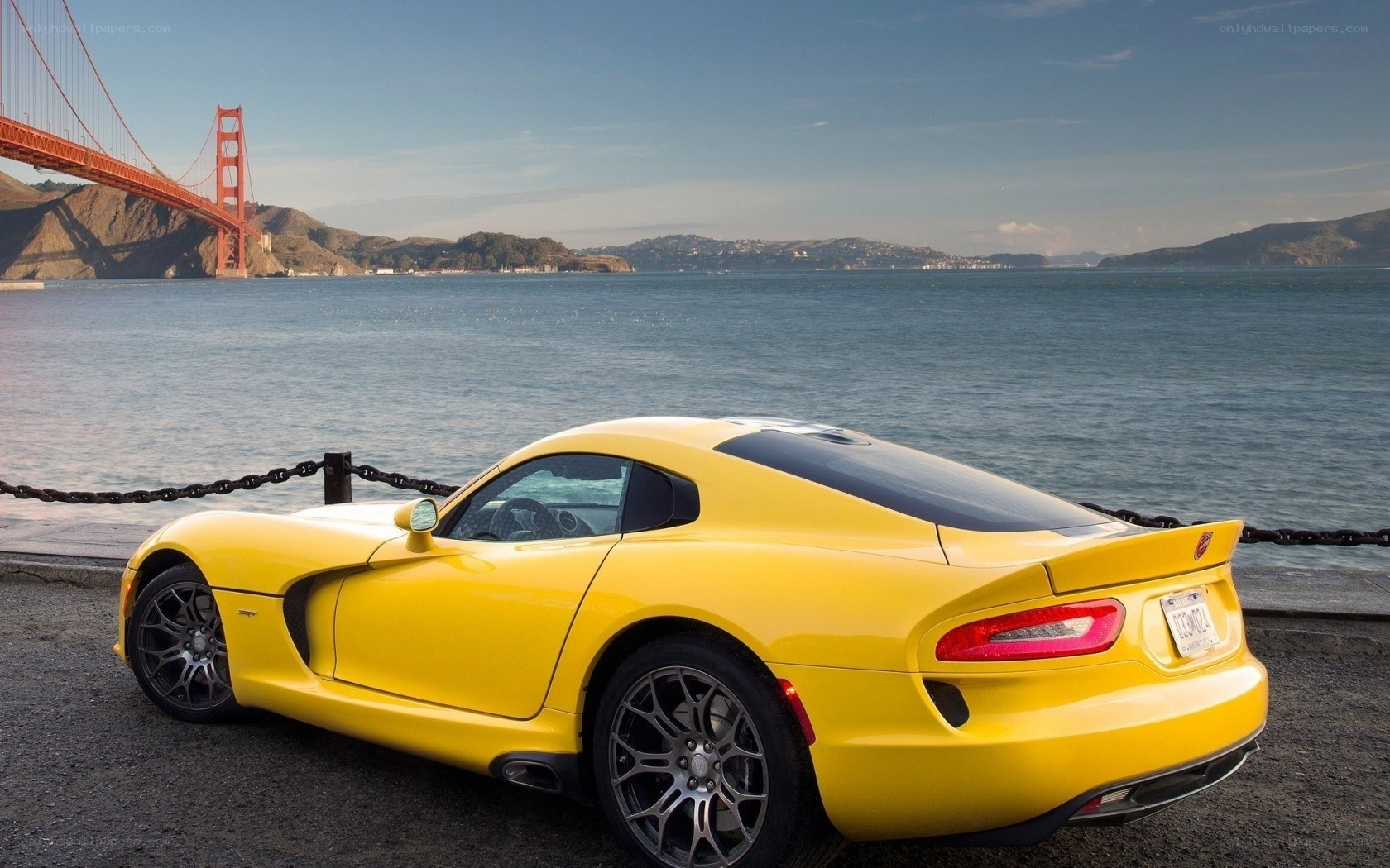 Yellow sports car by Golden Gate Bridge