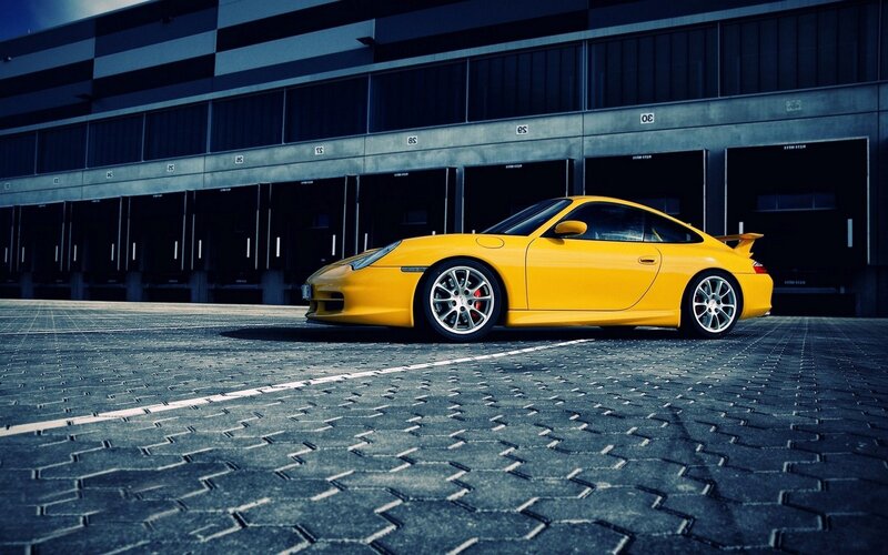 Yellow Sports Car — Dramatic, Photograph, Building, Pavement, Garage Doors