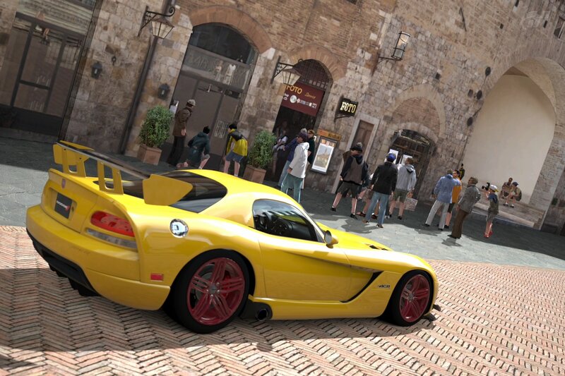 Yellow sports car in a town square