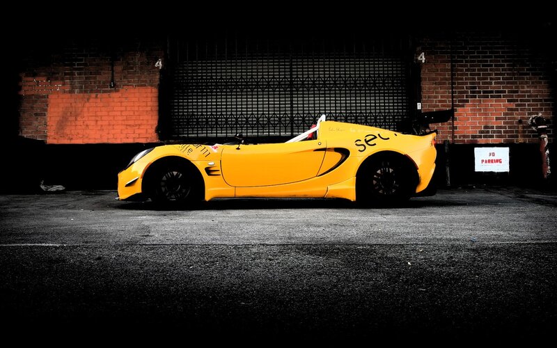 yellow sports car in alley