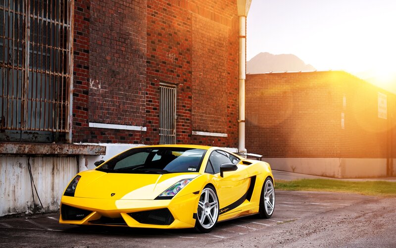 yellow sports car in alley