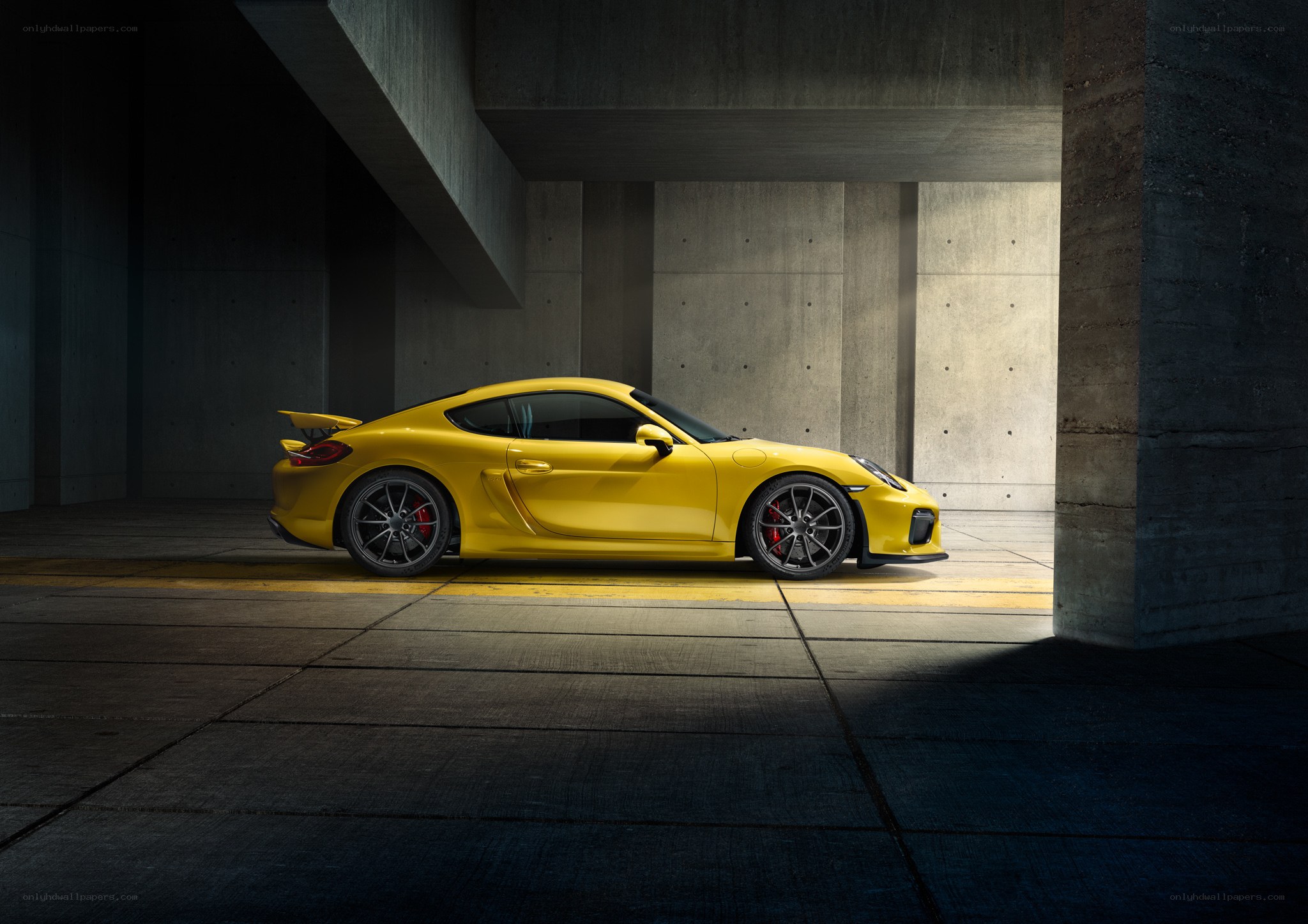 Yellow sports car in concrete garage