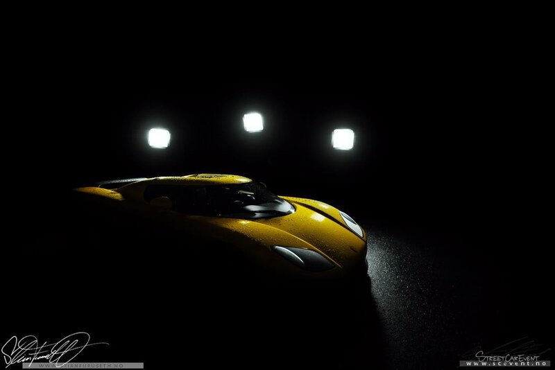 Yellow sports car in dark studio