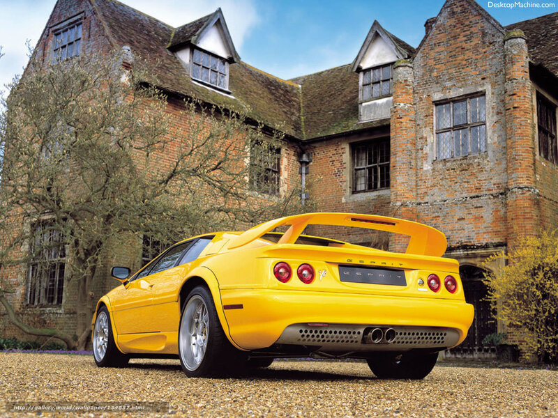 Yellow sports car in front of a brick house