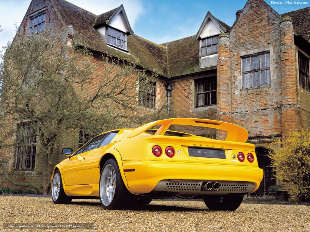 Yellow sports car in front of a brick house
