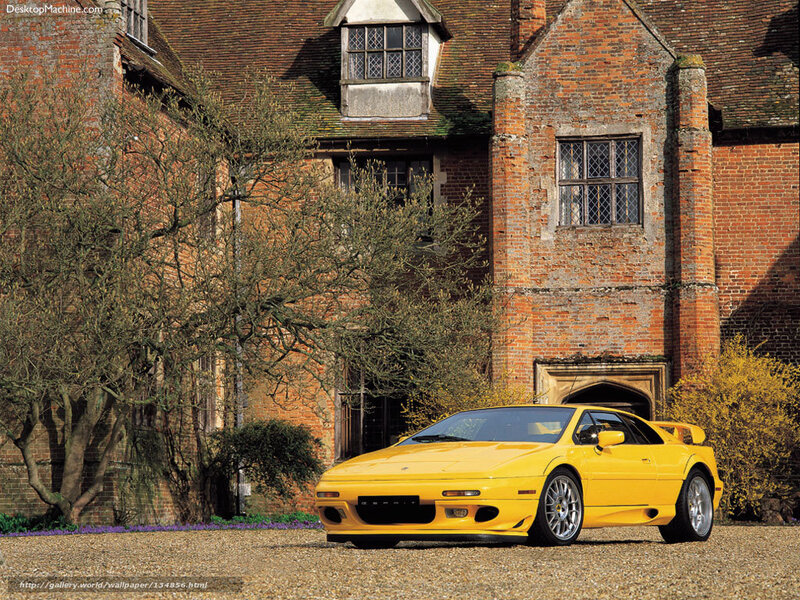Yellow sports car in front of brick house
