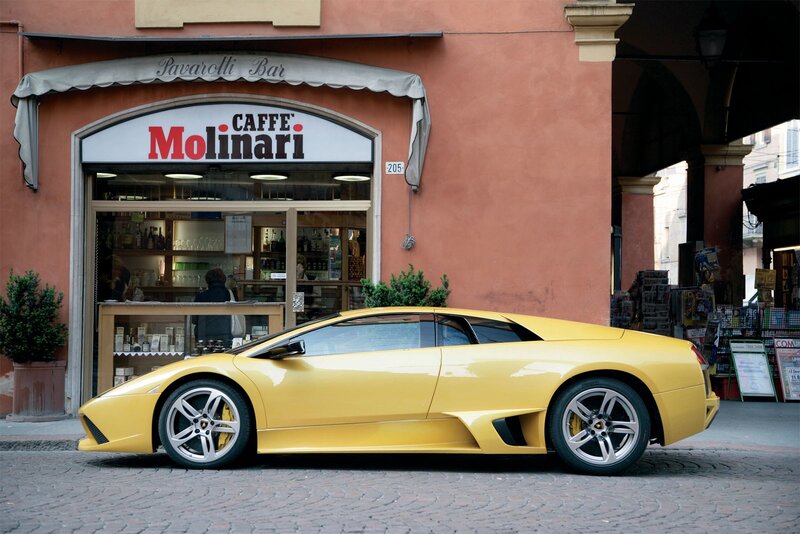 Yellow sports car in front of cafe