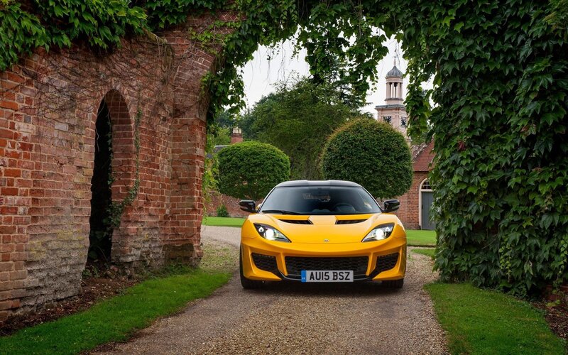 Yellow sports car in garden archway