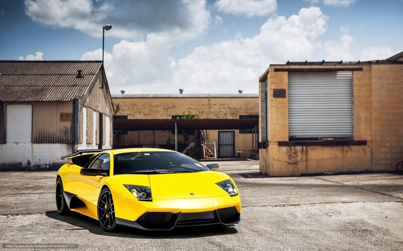 yellow sports car in industrial lot
