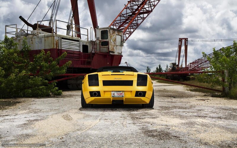 Yellow sports car in industrial yard