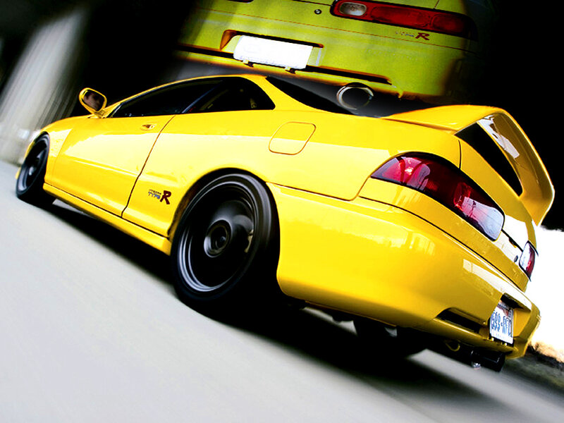 yellow sports car in motion