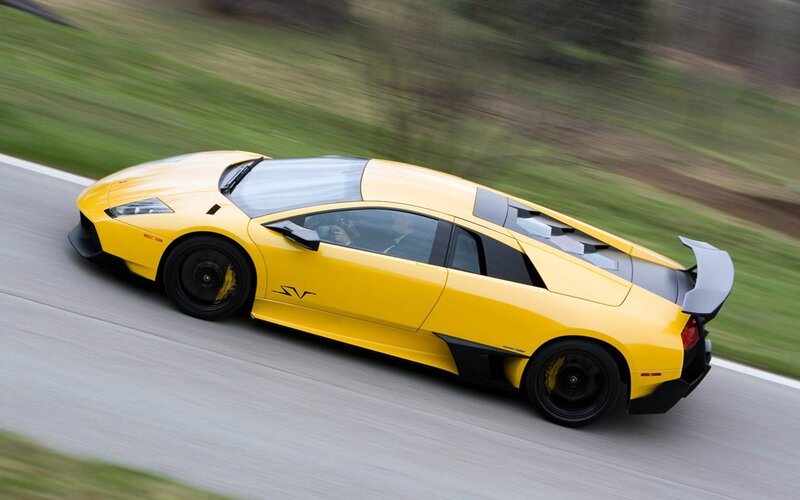 yellow sports car in motion