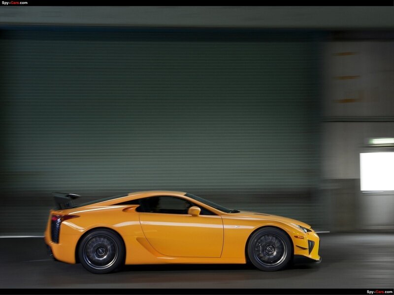 yellow sports car in motion