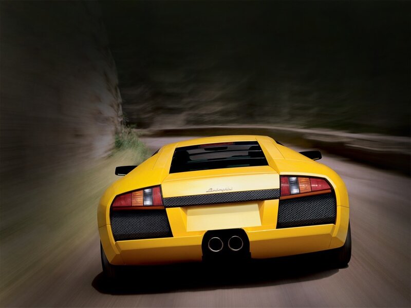 yellow sports car in motion