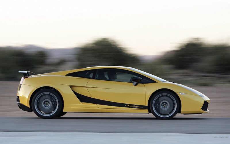 yellow sports car in motion